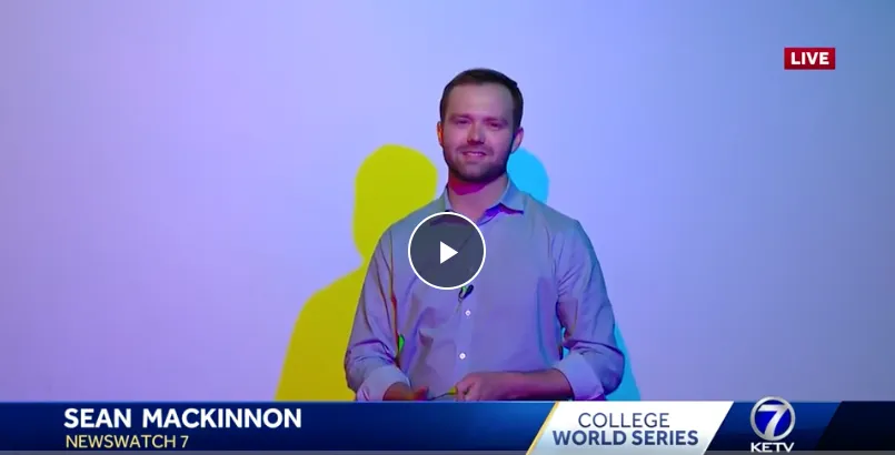 Sean McKinnon of KETV in front of the Colored Shadows Exhibit