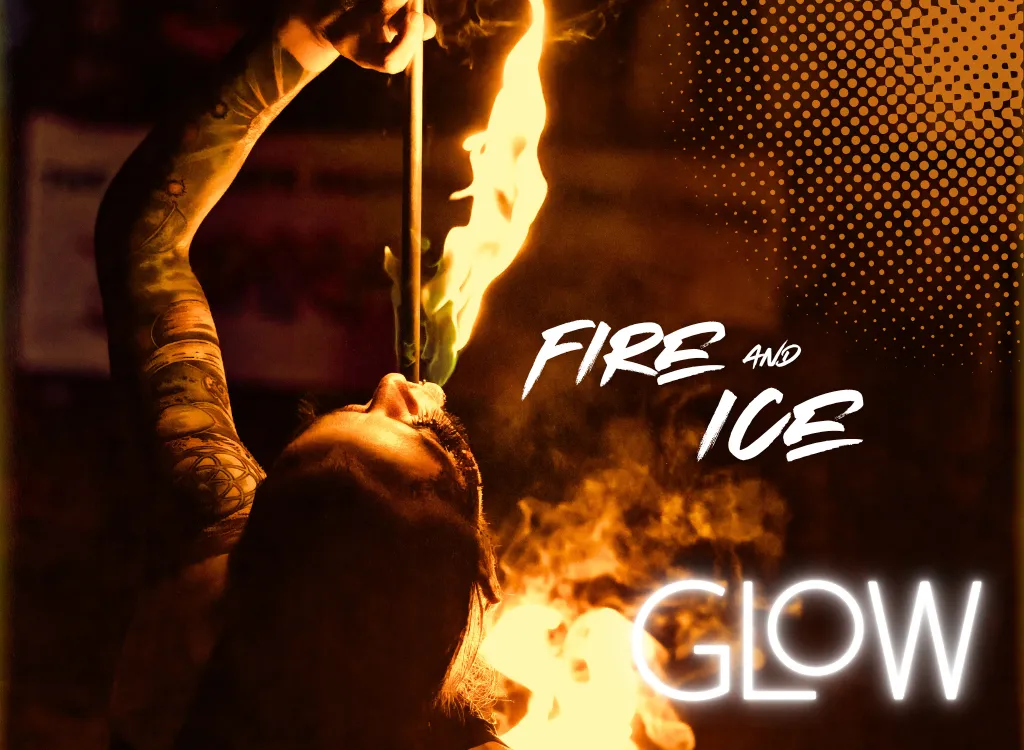 A fire performer breathes bright orange flames in a dimly lit setting. The words “GLOW” and “FIRE AND ICE” appear in bold white text.